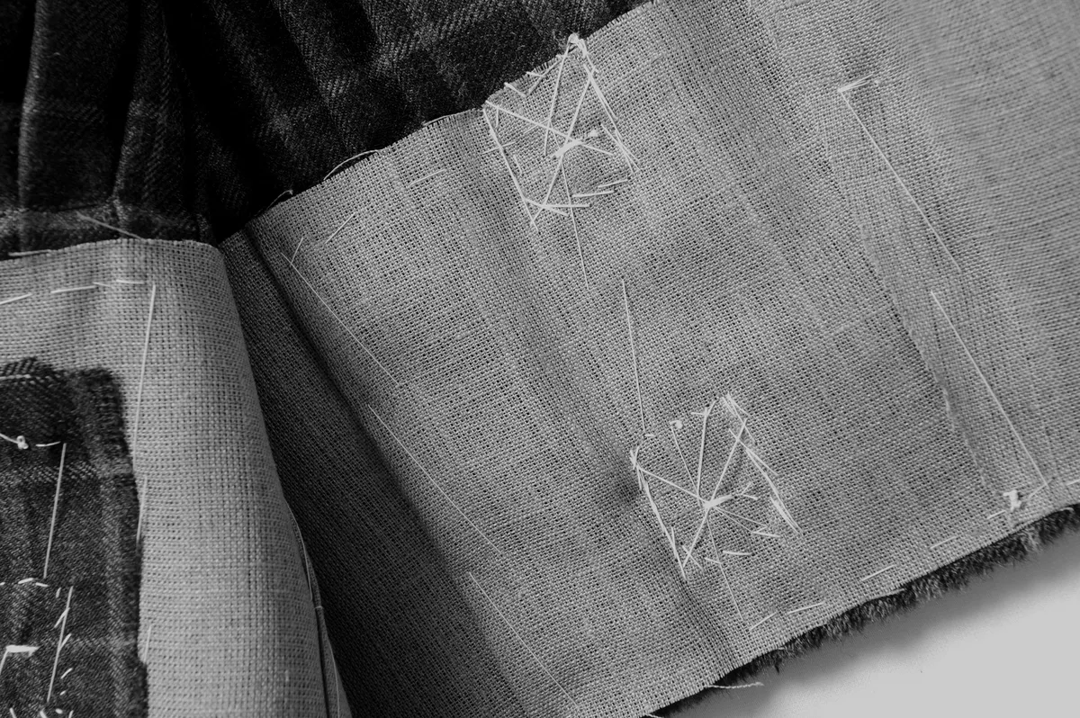 The kilt canvas, tacked by hand inside the pleats